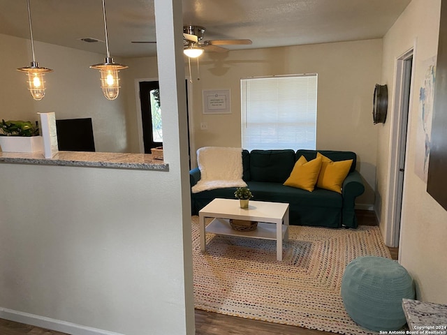 living room with ceiling fan and dark hardwood / wood-style floors