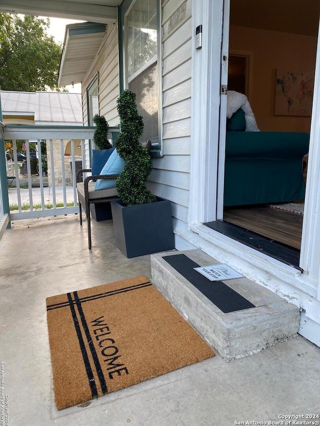 property entrance featuring covered porch