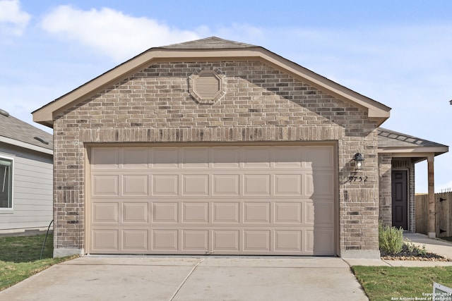 ranch-style home with a garage, a front yard, and central AC unit