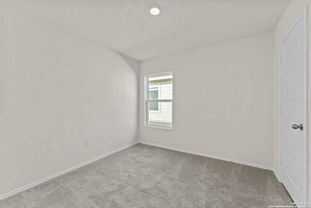 unfurnished bedroom featuring hardwood / wood-style flooring, a closet, ensuite bathroom, and vaulted ceiling