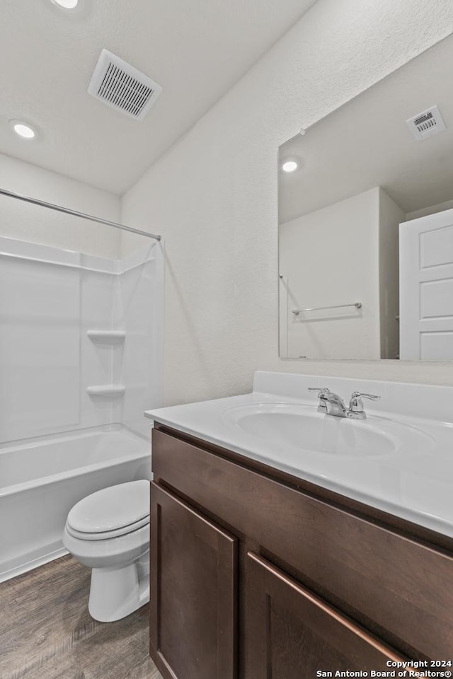 bathroom with hardwood / wood-style floors, toilet, and vanity