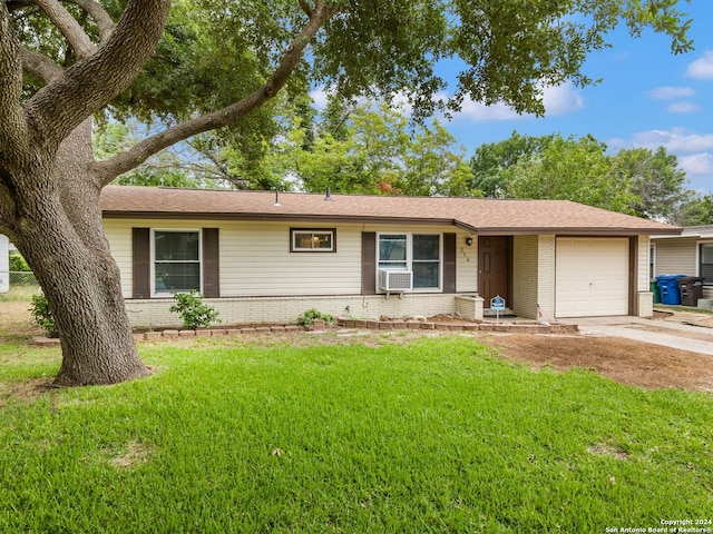 single story home with a garage, brick siding, concrete driveway, and a front yard