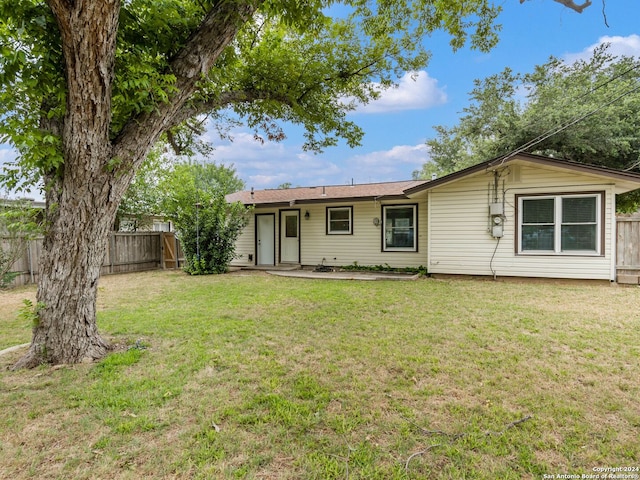 back of property featuring a yard and a patio