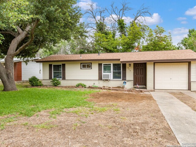 single story home with a front yard, concrete driveway, brick siding, and an attached garage