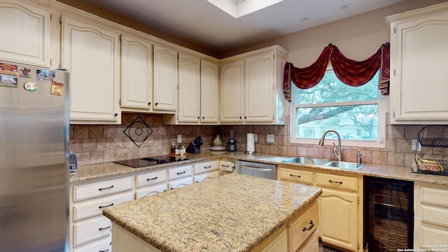 kitchen featuring sink, beverage cooler, backsplash, stainless steel appliances, and light stone countertops