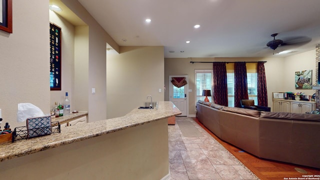 living room with sink and ceiling fan