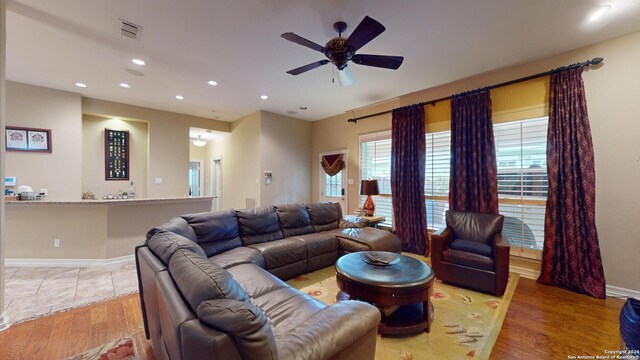 living room featuring ceiling fan and light wood-type flooring