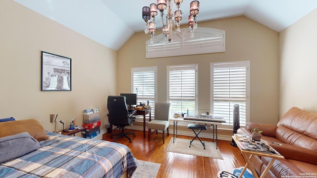 bedroom with hardwood / wood-style flooring, vaulted ceiling, and a chandelier