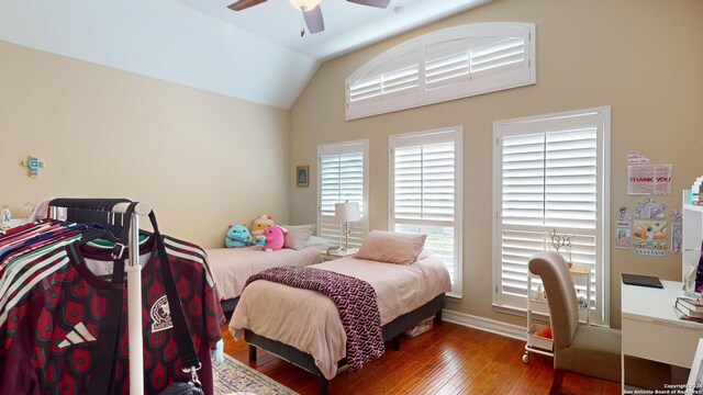 bedroom featuring dark hardwood / wood-style flooring, lofted ceiling, and ceiling fan