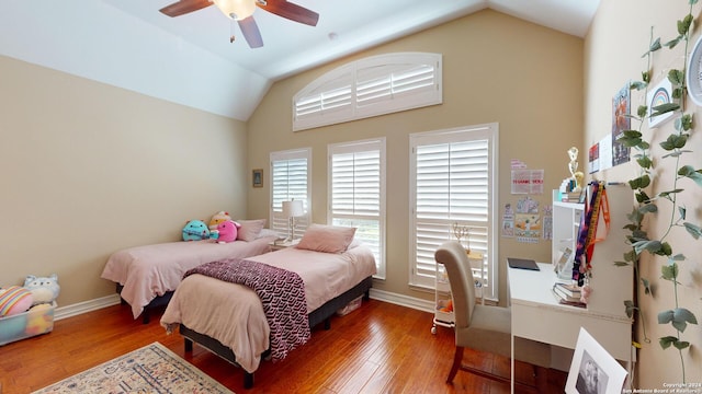 bedroom with hardwood / wood-style flooring, ceiling fan, and lofted ceiling