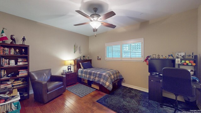 bedroom featuring dark wood-type flooring and ceiling fan