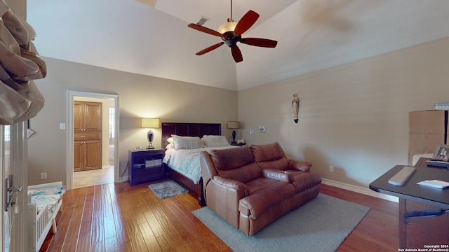 bedroom featuring hardwood / wood-style flooring, high vaulted ceiling, and ceiling fan