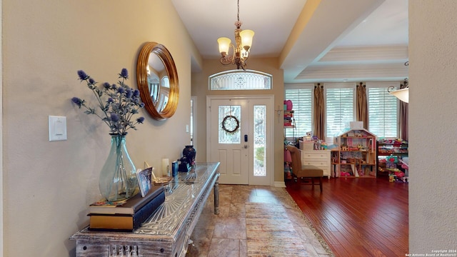 foyer featuring light hardwood / wood-style flooring and a notable chandelier