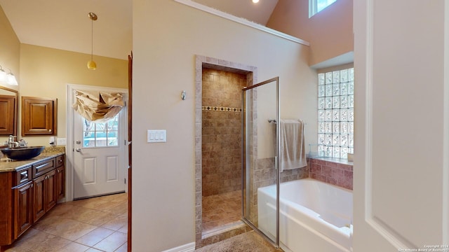 bathroom featuring vanity, vaulted ceiling, tile patterned floors, and plus walk in shower