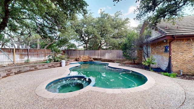 view of pool with a patio and an in ground hot tub