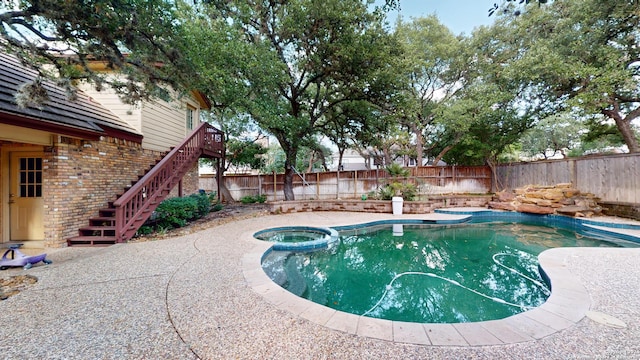 view of swimming pool featuring an in ground hot tub