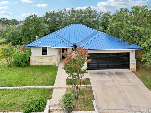 view of front of house with a garage and a front lawn