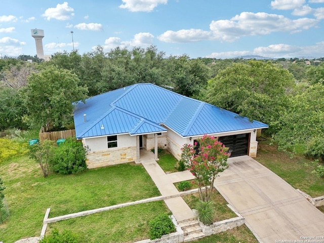 view of front facade with a front yard and a garage