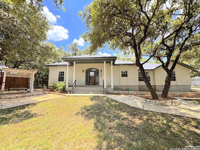 back of property featuring a yard and a porch