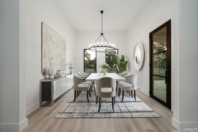 dining area featuring a notable chandelier and light hardwood / wood-style flooring