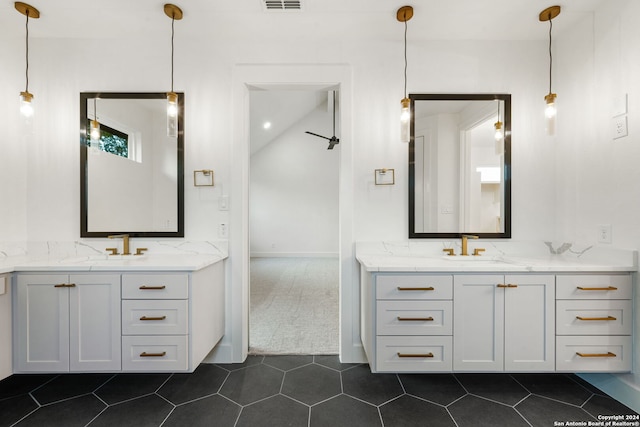 bathroom featuring vanity, tile patterned floors, and vaulted ceiling