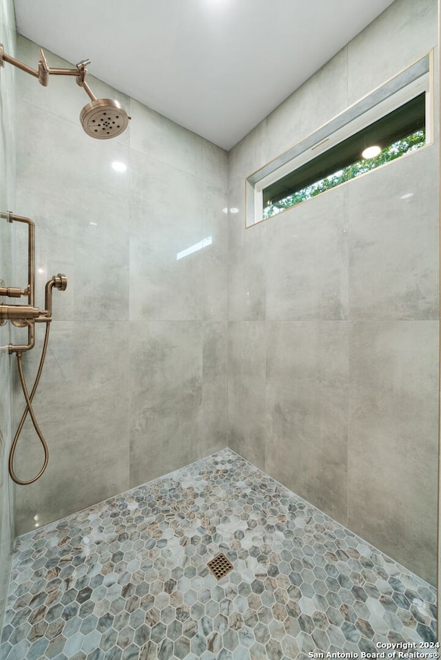 bathroom with tiled shower