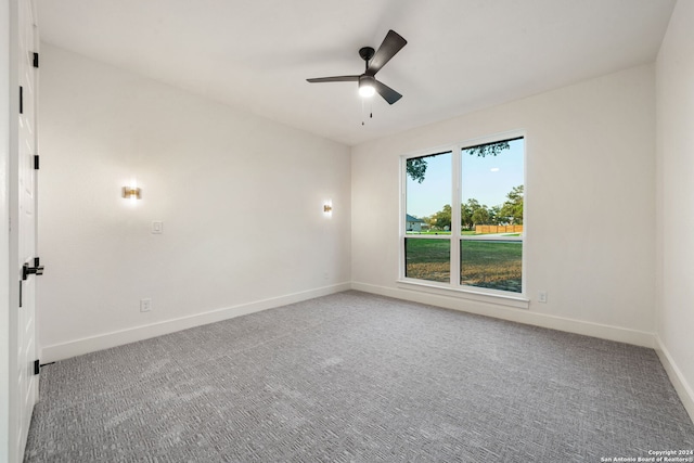 carpeted spare room with ceiling fan