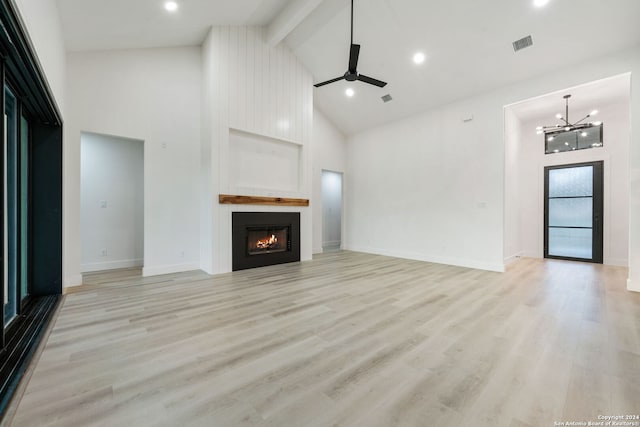 unfurnished living room featuring high vaulted ceiling and light wood-type flooring