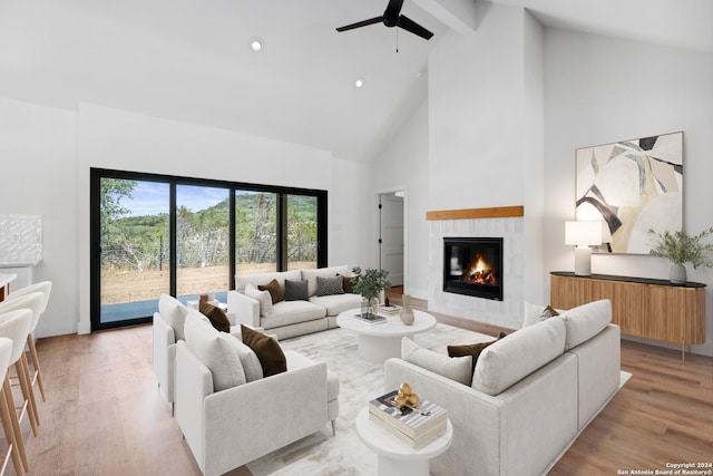 living room with high vaulted ceiling, light hardwood / wood-style flooring, and ceiling fan