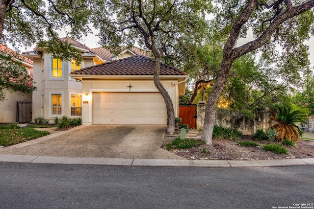 mediterranean / spanish house featuring a garage