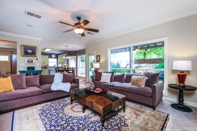 living room featuring ceiling fan and ornamental molding