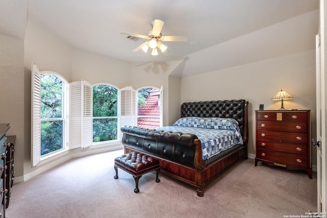 carpeted bedroom featuring ceiling fan and vaulted ceiling