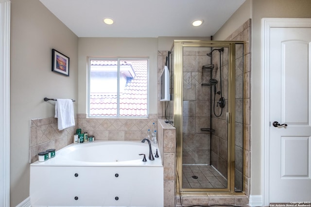 bathroom featuring separate shower and tub