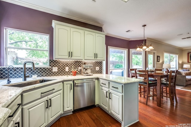 kitchen with sink, light stone counters, hanging light fixtures, dark hardwood / wood-style floors, and dishwasher