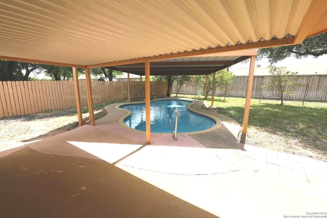 view of swimming pool with a yard and a patio