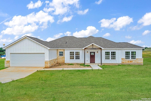 single story home featuring a garage and a front yard