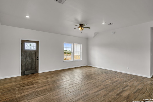 unfurnished living room featuring a healthy amount of sunlight, ceiling fan, and dark hardwood / wood-style floors