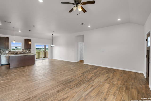 unfurnished living room with vaulted ceiling, light hardwood / wood-style floors, and ceiling fan