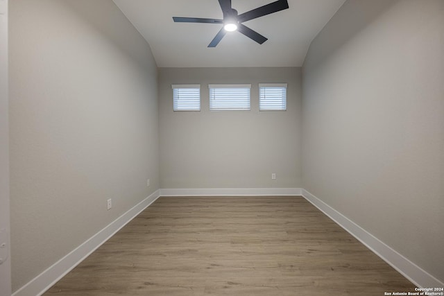 empty room with ceiling fan, light hardwood / wood-style flooring, and lofted ceiling