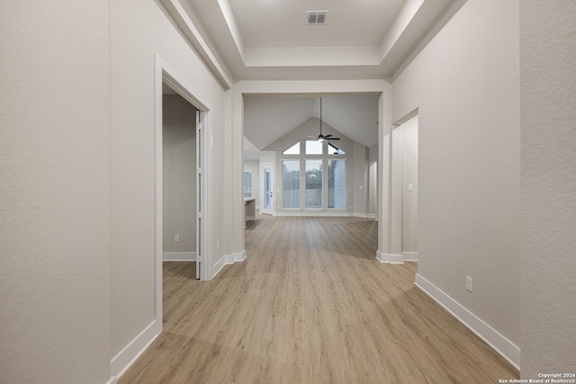 hallway featuring vaulted ceiling and light wood-type flooring