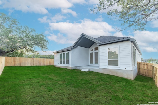 rear view of house with a yard