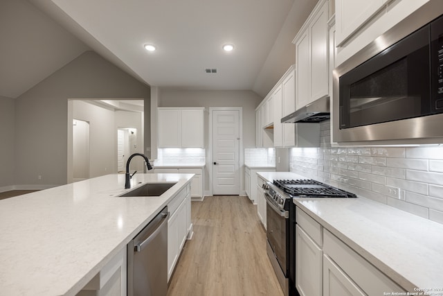 kitchen featuring white cabinets, light wood-type flooring, stainless steel appliances, and sink