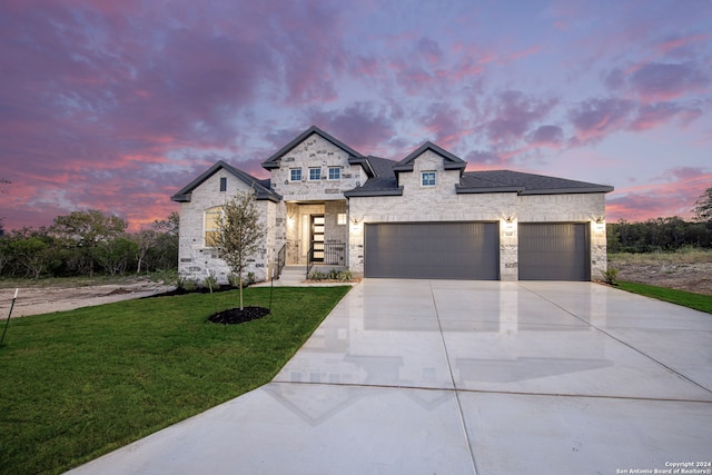 view of front of home with a lawn and a garage