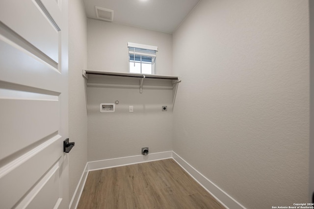 washroom featuring washer hookup, electric dryer hookup, gas dryer hookup, and hardwood / wood-style floors