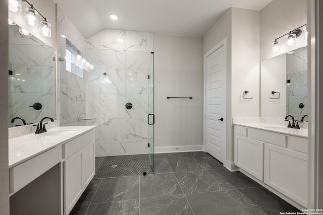 bathroom featuring vanity, a shower with shower door, and vaulted ceiling