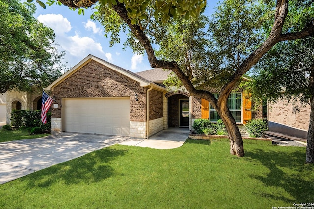 view of front of property featuring a garage and a front lawn