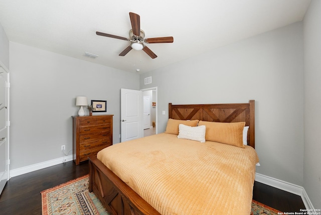 bedroom with ceiling fan and dark wood-type flooring