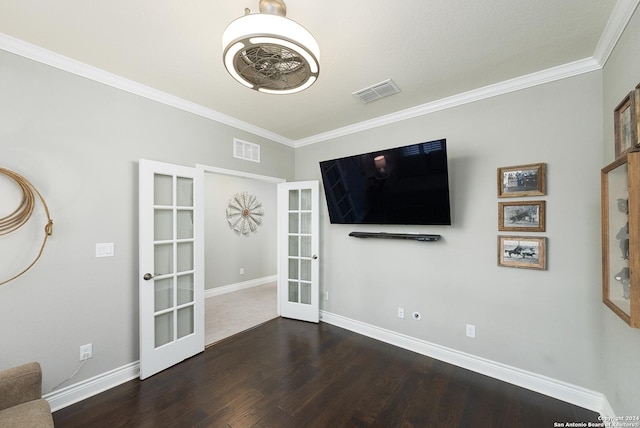 unfurnished living room with french doors, dark hardwood / wood-style flooring, and crown molding