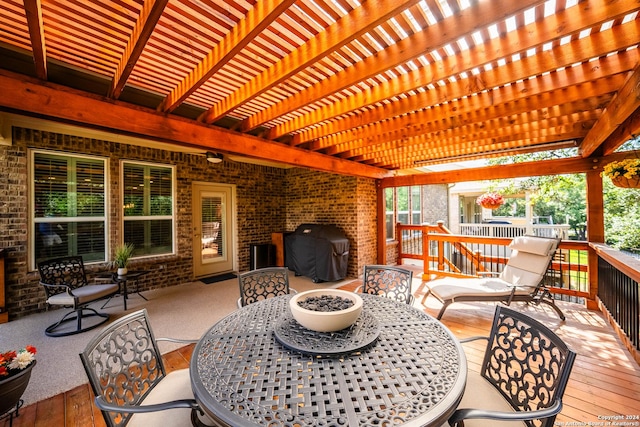 wooden terrace featuring area for grilling and a pergola