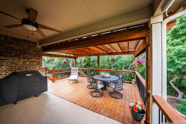 wooden deck with grilling area and ceiling fan